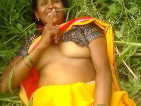 Indian bhabhi's outdoor boob play in village