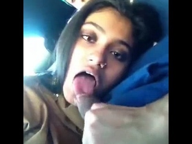 An Indian girlfriend performs oral sex on her boyfriend in a vehicle