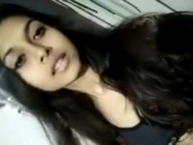 A stunning Indian babe seductively strips