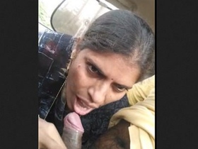 Mature Randi gives a blowjob to a client in a car