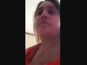 A horny Pakistani wife with big boobs indulges in naughty behavior