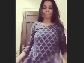 A young adult wearing a striped outfit misbehaves in the restroom