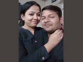 Attractive pair kissing in professional setting