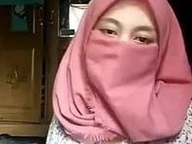 A girl wearing a hijab strips on webcam