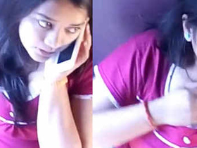 A pretty Indian college girl lightly touches and scratches her breast on a train without exposing herself
