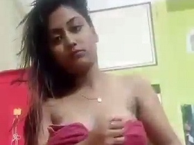 Watch a stunning girl with a tattoo on her chest strip down and show off her body