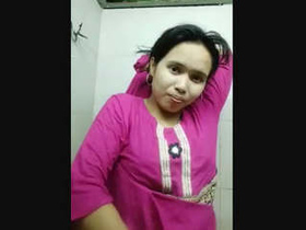 A stunning woman indulges in self-pleasure and displays her intimate areas