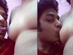 A guy pleasuring his girlfriend's breasts