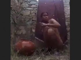 Village wife relaxes in open-air bath