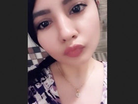 A well-endowed woman proudly displays her large breasts