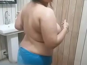 Explore the hidden desires of a bhabha with big boobs in a risqué bathroom video
