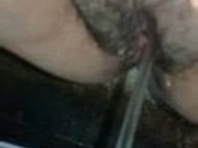 A woman relieves herself on camera