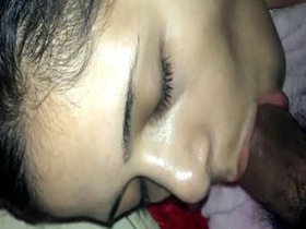 A charming South Asian woman enjoys giving a deep oral pleasure to a penis