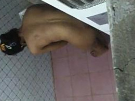 An Indian woman takes a bath