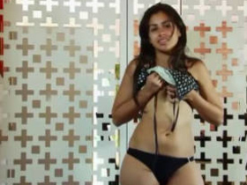 Pretty Indian girl teases with cute facial expressions, showing off her body