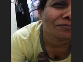 Aunty gives a blowjob to her lover while chatting