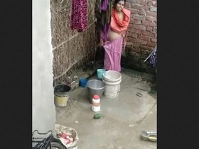 Indian bhabhi takes a bath in the open air