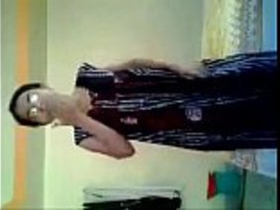 A young Indian woman undresses on camera