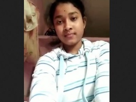 A charming South Asian woman displays her breasts and vagina in a video