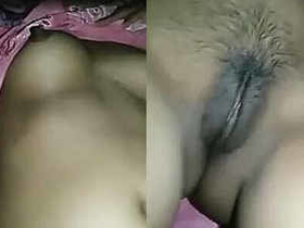 A young woman of South Asian descent indulges in self-pleasure, showcasing her breasts and stimulating her intimate area