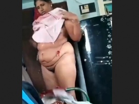 A mature Indian woman is filmed in the tub