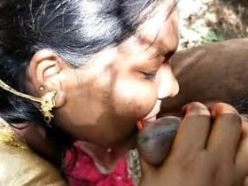 Indian wife in saree performs oral sex on her husband outdoors