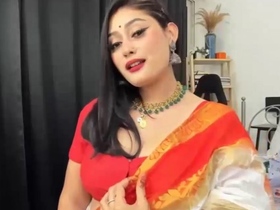 Anna, the cute one, wears a sexy orange sari in a live video